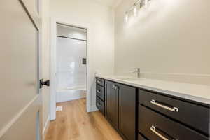 Upstairs hall Bathroom with vanity, toilet, and wood-type flooring. 2411 S.