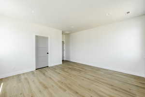 Owner's suite with light hardwood / wood-style floors. 2411 S.