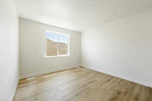 The upstairs bedroom room features light hardwood / wood-style flooring. 2411 S.