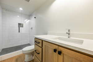 Bathroom featuring vanity, toilet, wood-type flooring, and a shower with door. 2425 S.