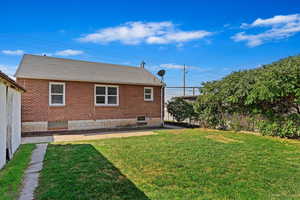 Back of house with a yard