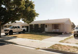 Ranch-style home featuring a front yard