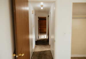 Hallway featuring carpet flooring