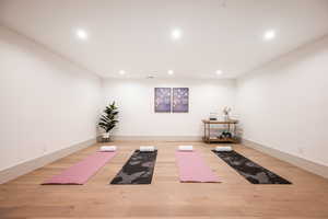 Workout area with light wood-type flooring