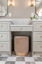 Bathroom featuring vanity and tile walls