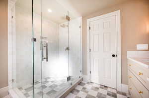 Bathroom featuring walk in shower and vanity