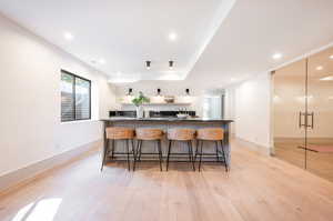 Kitchen featuring a kitchen breakfast bar and light hardwood / wood-style flooring