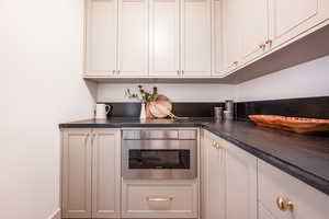 Kitchen with white cabinets and oven