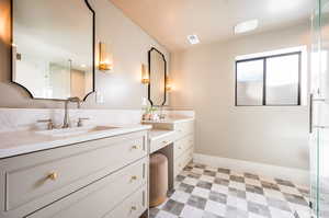 Bathroom featuring walk in shower and vanity