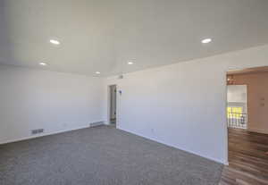 Spare room featuring a textured ceiling and hardwood / wood-style floors