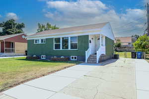 Bungalow-style house with central AC and a front yard