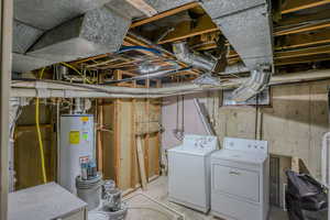 Basement with gas water heater and washer and clothes dryer