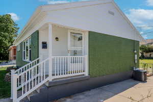 View of front of house featuring central air condition unit and covered porch