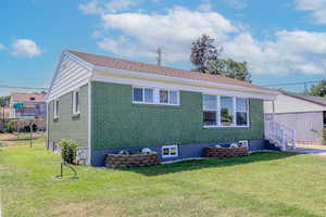 Rear view of house with a yard