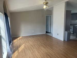 Interior space featuring lofted ceiling, ceiling fan, and hardwood / wood-style floors