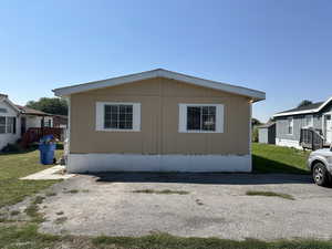 View of side of property with a yard