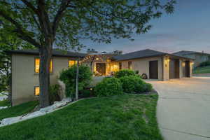 View of front of home with a garage and a lawn