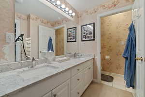 Bathroom featuring tile patterned floors, toilet, and vanity