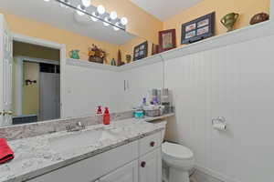 Bathroom featuring vanity and toilet