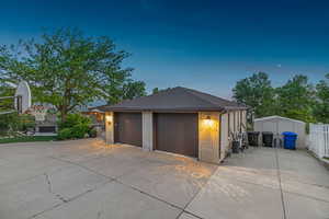 View of garage at dusk