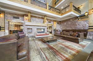 Lobby with a high ceiling and a stone fireplace