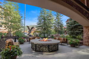 View of patio with an outdoor living space with a fire pit