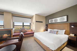 Carpeted bedroom featuring a textured ceiling