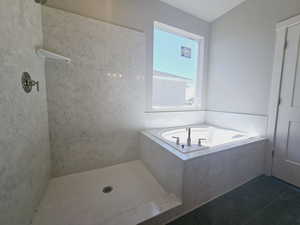 Bathroom featuring tile patterned flooring and plus walk in shower