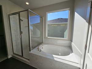 Bathroom featuring separate shower and tub and tile patterned flooring