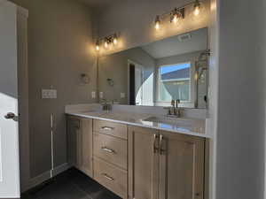 Bathroom with vanity and tile patterned floors