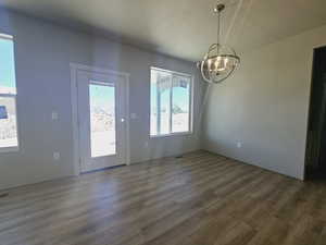 Doorway featuring a chandelier, plenty of natural light, and dark hardwood / wood-style flooring