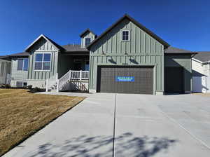 View of front of house featuring a front yard and a garage