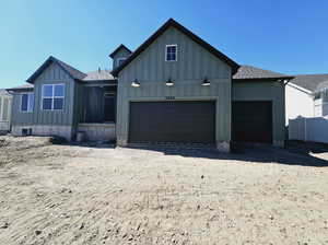 View of front facade featuring a garage