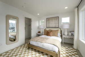 Bedroom with a closet, a spacious closet, and light carpet  *Model Home Photo. Colors and finishes will vary.