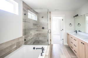 Huge Bathroom with walk-in glass shower, 6 foot tub, tile surrounds and double vanity