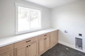 Large Laundry Room with plenty of cabinet and countertop space.