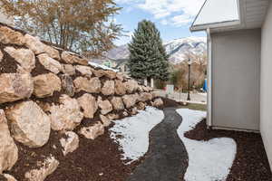 Yard layered in snow with a mountain view