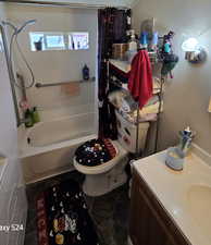 Full bathroom featuring vanity, toilet, tile patterned floors, and shower / bath combination with curtain