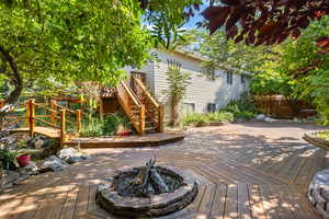 Backyard oasis with firepit, relaxing stream and pond, hot tub, and separate entrance to basement.