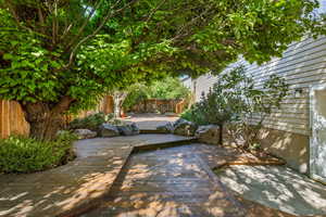 Backyard oasis with firepit, relaxing stream and pond, hot tub, and separate entrance to basement.