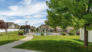 View of community with a lawn and a pool