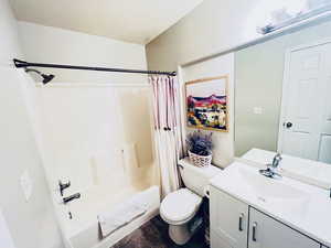 Full bathroom featuring vanity, toilet, shower / tub combo with curtain, and LVT SQUARE FLOORING