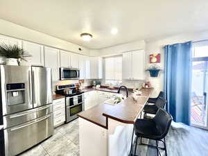 LOVELY KITCHEN WITH UPGRADED SS APPLIANCES (NOTE THE DOUBLE OVEN RANGE)