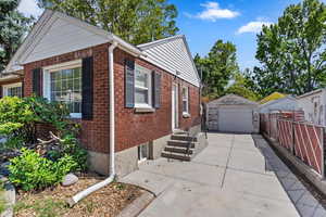 View of side of property featuring an outbuilding and a garage