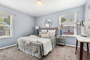 Bedroom featuring light colored carpet