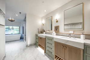 Bathroom featuring a tub to relax in and vanity