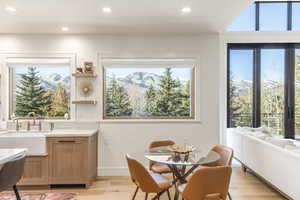 Dining room with a mountain view, sink, and a healthy amount of sunlight
