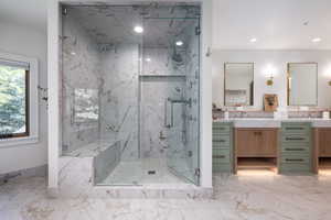 Bathroom with vanity and a shower with door