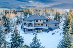 Snow covered house with a deck