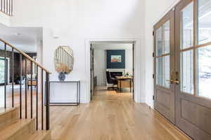 Foyer featuring light hardwood / wood-style floors and french doors
